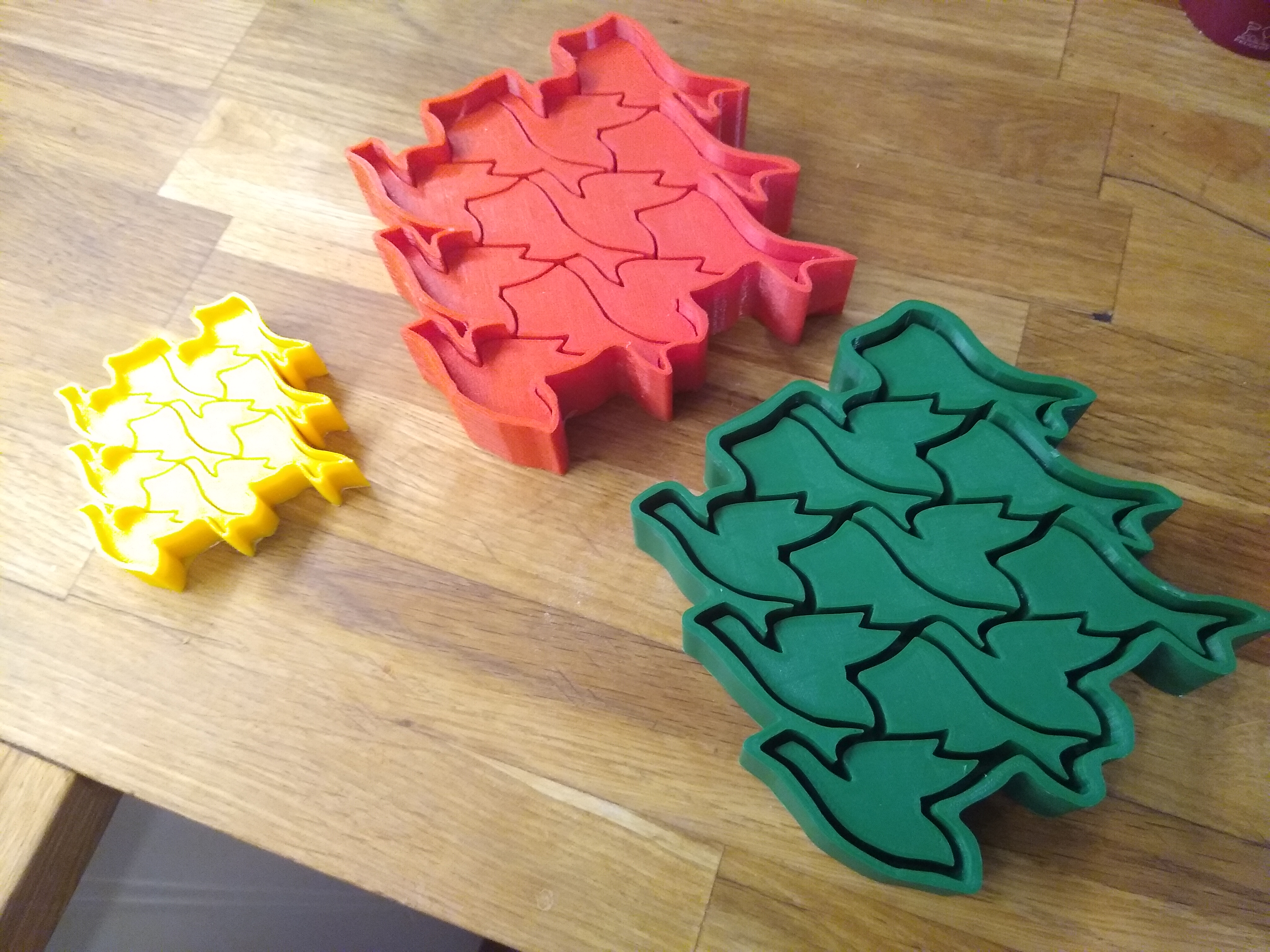 The three molds. From left to right, the first mold (yellow), second (red), and third (green)